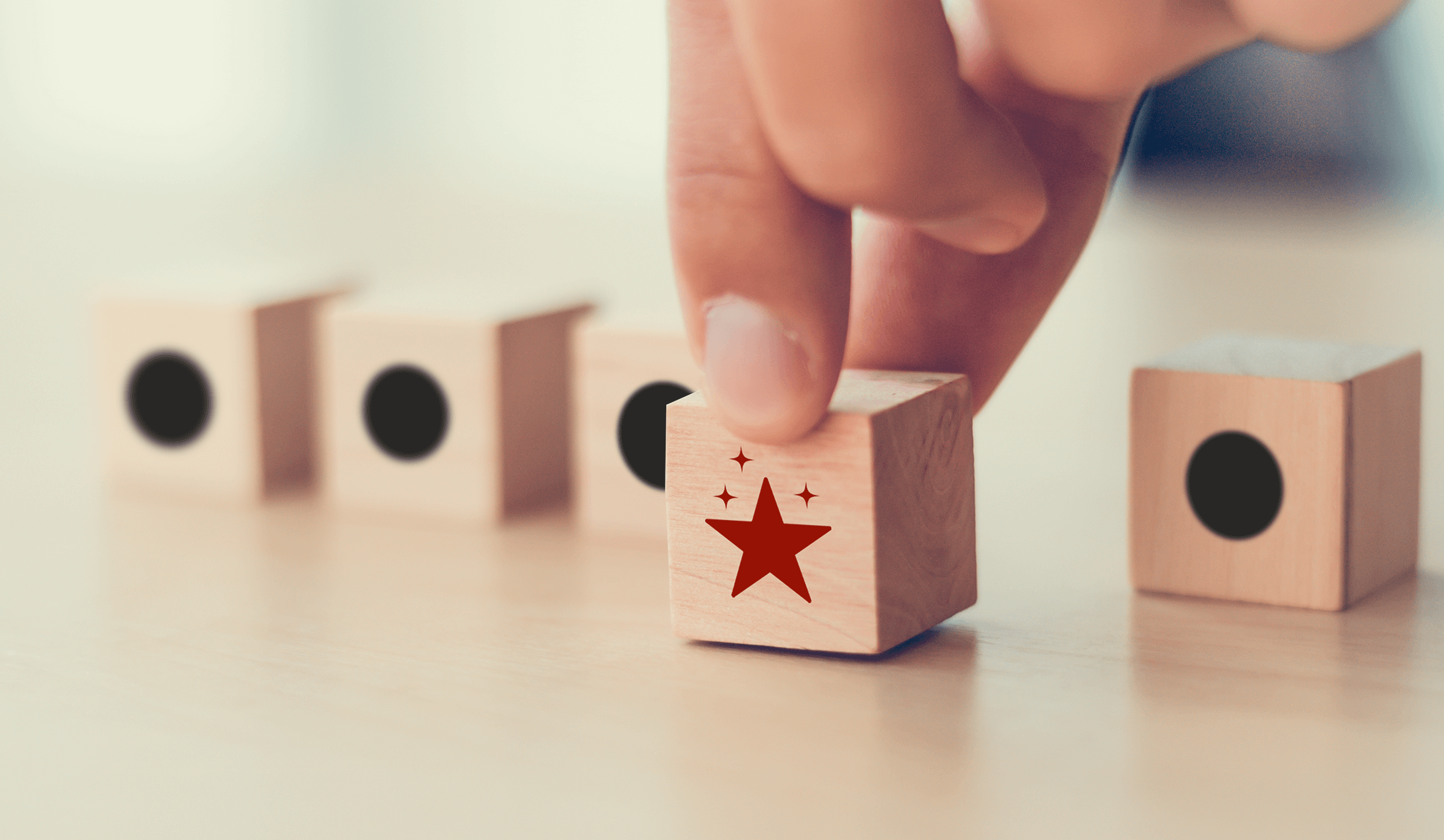 Hand placing wooden block with red star rating among neutral blocks, symbolizing online reviews, brand reputation management, and customer trust optimization.