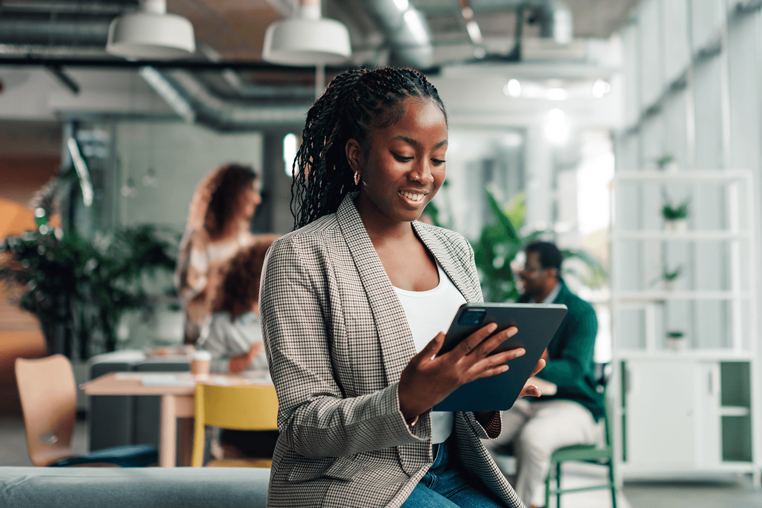 Marketing professional reviewing content on a tablet in a modern office, representing real-time AI retrieval, content visibility, and citation potential in AI-driven search.