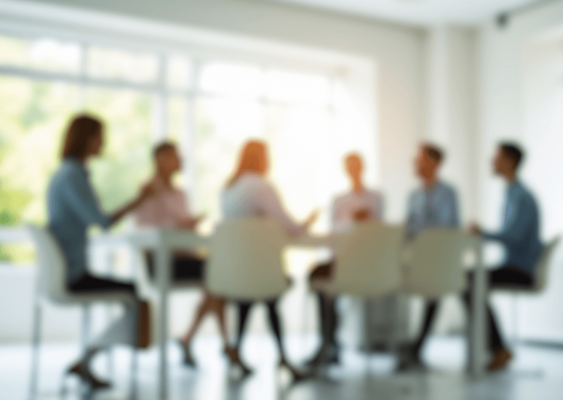 Blurred image of a digital PR team meeting around a conference table, representing strategic collaboration, data-driven planning, and authority-focused outreach in the evolving 2026 PR landscape.