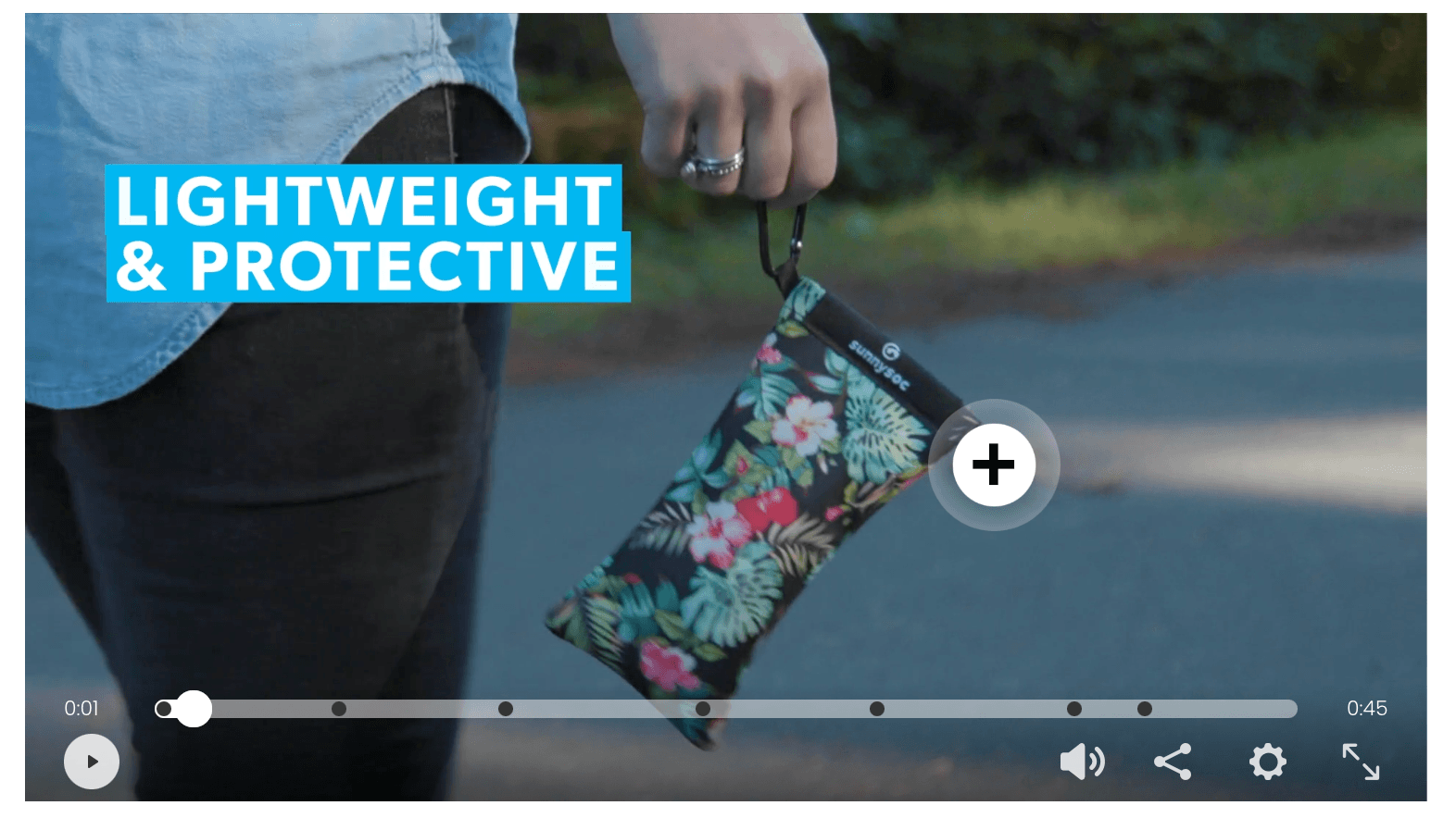 Interactive product video with clickable hotspot highlighting a lightweight protective pouch being carried by a person outdoors.