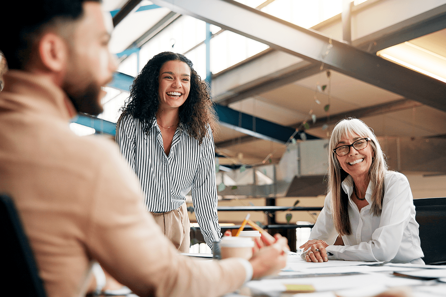 Team meeting in a modern office, illustrating the strategic collaboration behind brand messaging, content planning, and media pitching that drives earned media coverage.