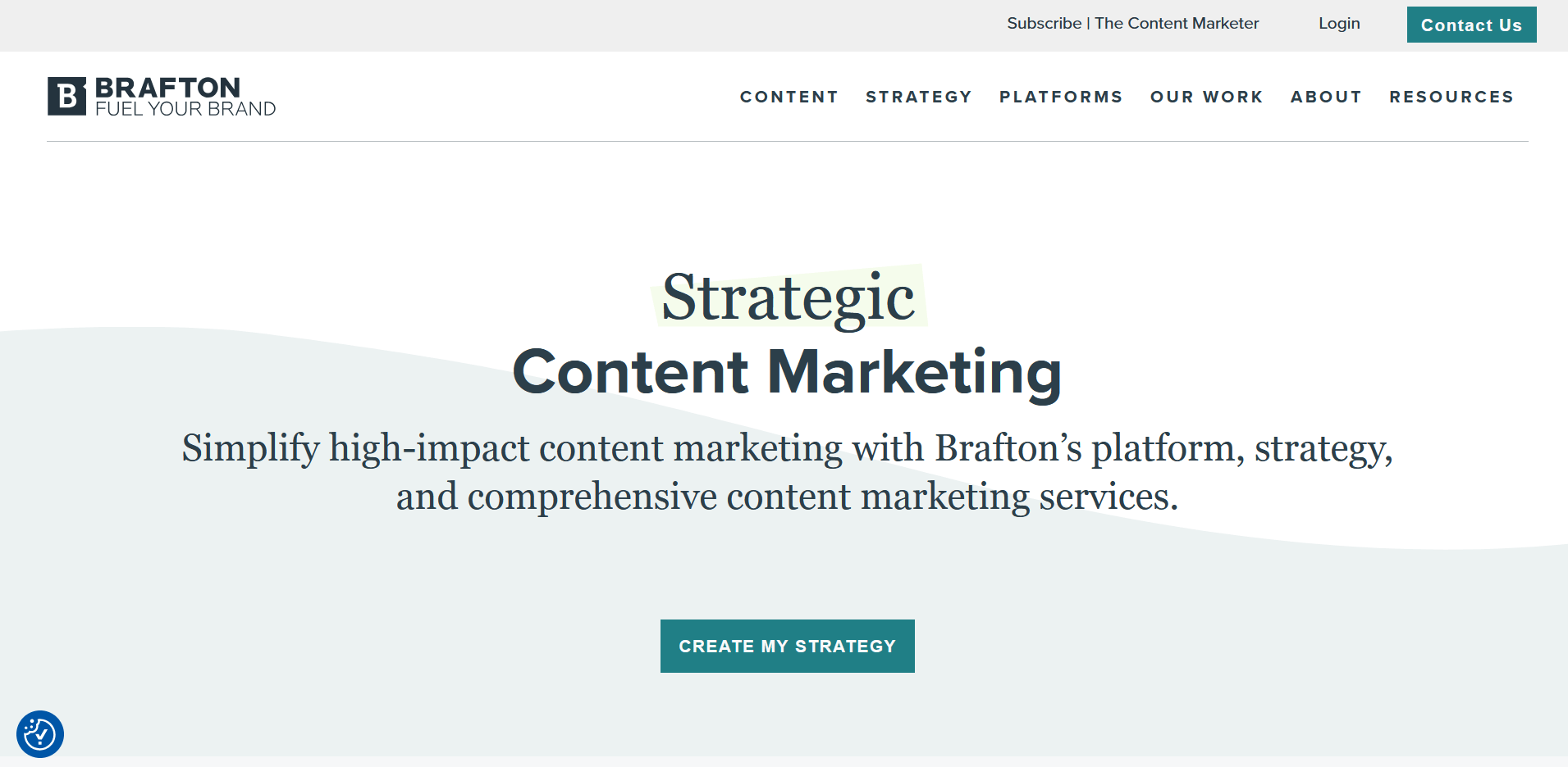 A clean, professional website homepage features the headline “Strategic Content Marketing” with supporting text promoting Brafton’s platform and services. A teal button labeled “Create My Strategy” is centered beneath the tagline.